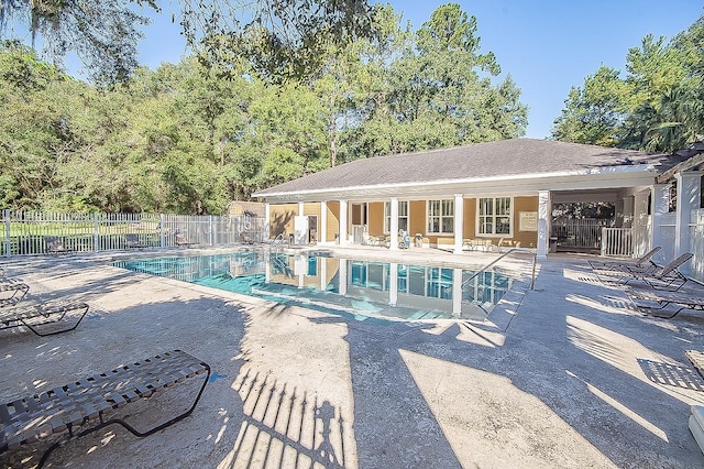 community pool featuring a patio area and fence