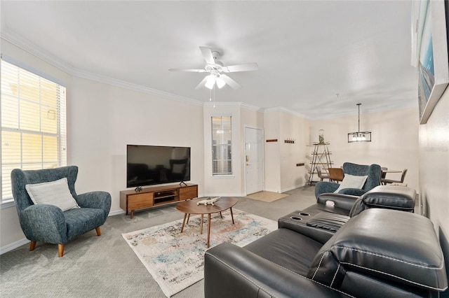 living area featuring baseboards, carpet floors, ornamental molding, and a ceiling fan