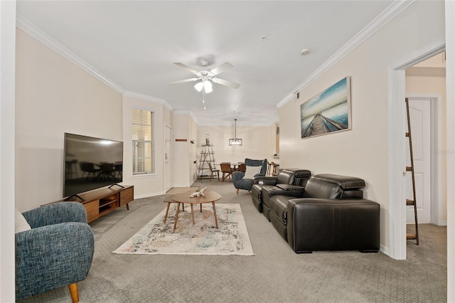 living room with ceiling fan, baseboards, ornamental molding, and carpet flooring