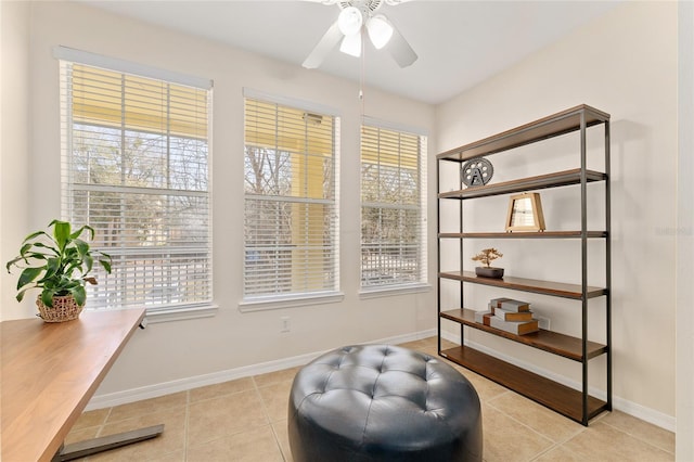 sitting room featuring a wealth of natural light, baseboards, ceiling fan, and tile patterned flooring