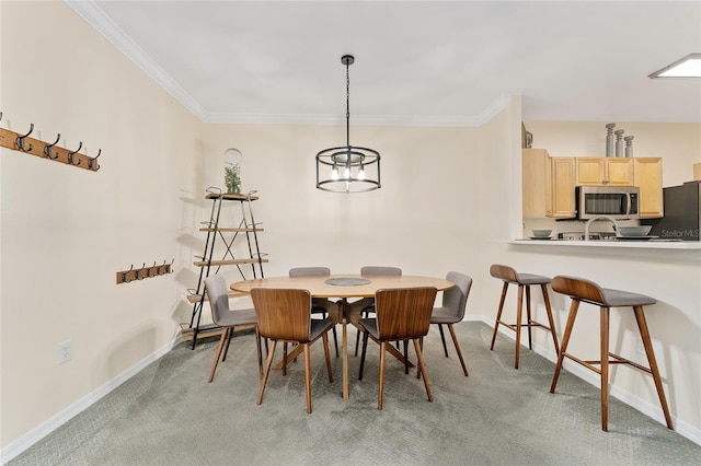 dining space featuring baseboards, light carpet, and ornamental molding