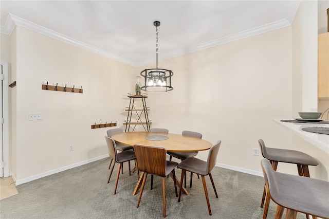 carpeted dining area with an inviting chandelier, crown molding, and baseboards