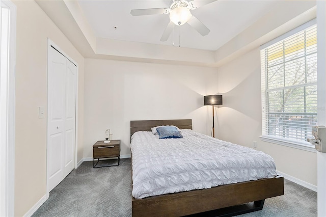 bedroom featuring a closet, carpet flooring, ceiling fan, and baseboards