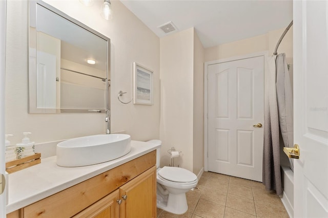 bathroom featuring visible vents, toilet, vanity, and tile patterned flooring