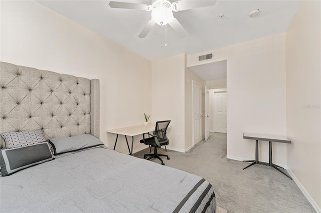 carpeted bedroom with visible vents, baseboards, and a ceiling fan