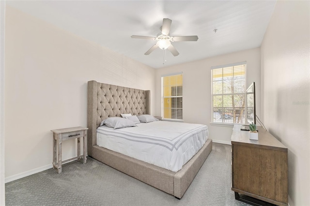 carpeted bedroom featuring baseboards and ceiling fan