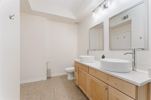 full bath with visible vents, a sink, tile patterned flooring, double vanity, and baseboards