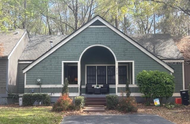 view of front of property with covered porch and roof with shingles