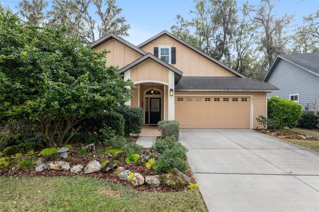 craftsman-style home with board and batten siding, concrete driveway, roof with shingles, and an attached garage