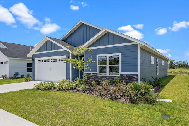 craftsman inspired home featuring an attached garage, stone siding, board and batten siding, and a front yard