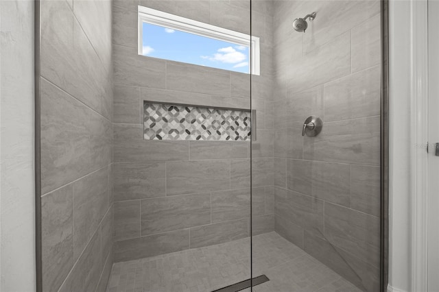 bathroom with tiled shower