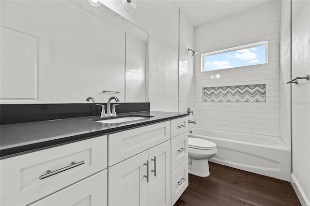 bathroom with vanity, shower / bath combination, wood finished floors, and toilet