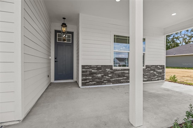 property entrance featuring stone siding