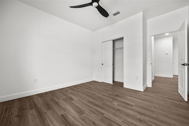 unfurnished bedroom with baseboards, visible vents, and wood finished floors