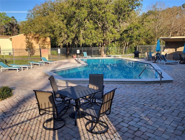 pool featuring a patio area and fence