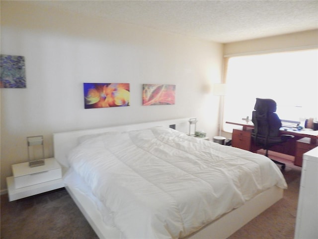 bedroom with a textured ceiling and carpet floors