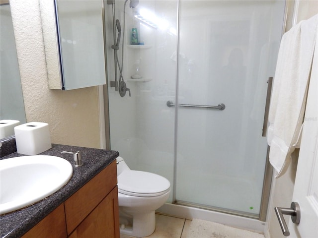 full bathroom with toilet, a stall shower, tile patterned floors, and vanity