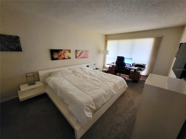 bedroom with dark carpet and a textured ceiling