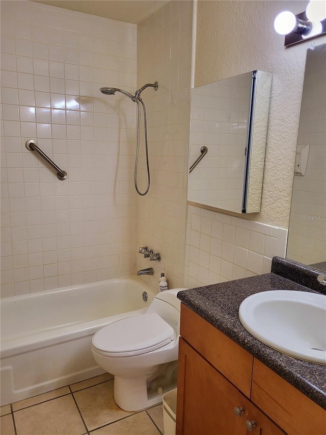 full bath with toilet, tile patterned flooring, washtub / shower combination, and a textured wall