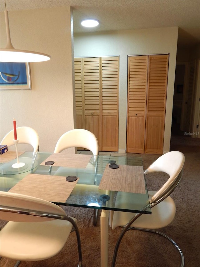 dining room featuring a textured ceiling