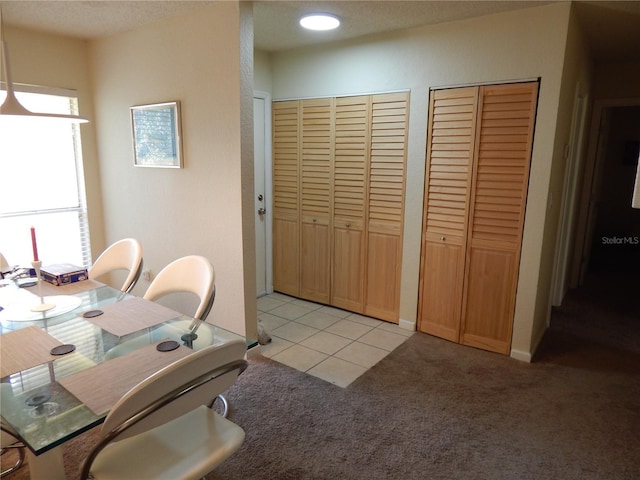 office space featuring a wealth of natural light, light carpet, and light tile patterned floors