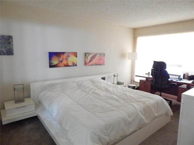 carpeted bedroom with a textured ceiling