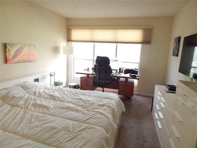 carpeted bedroom featuring a textured ceiling and baseboards