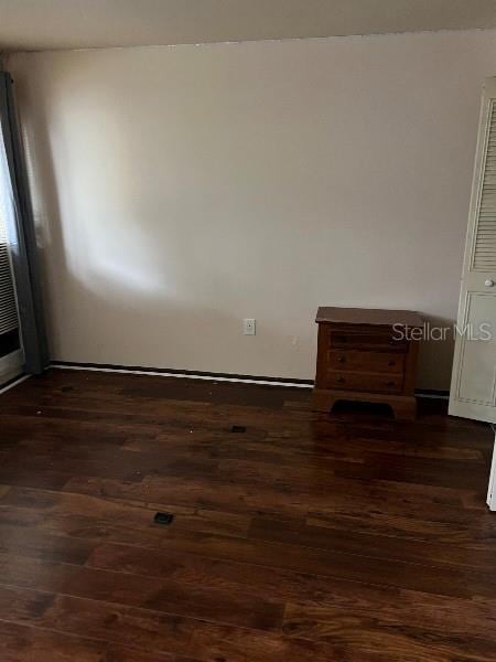 spare room featuring dark wood-style flooring