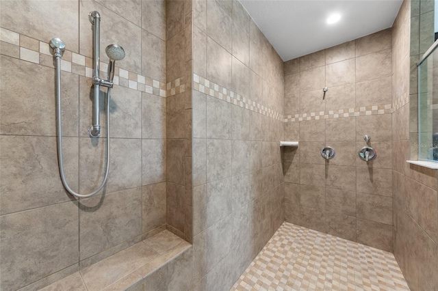 bathroom with tiled shower