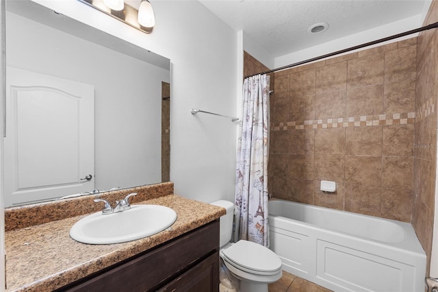 bathroom with a textured ceiling, toilet, shower / tub combo, vanity, and tile patterned floors