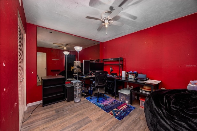 office featuring wood finished floors, a textured ceiling, and ceiling fan