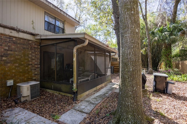 view of yard featuring cooling unit, a sunroom, and fence