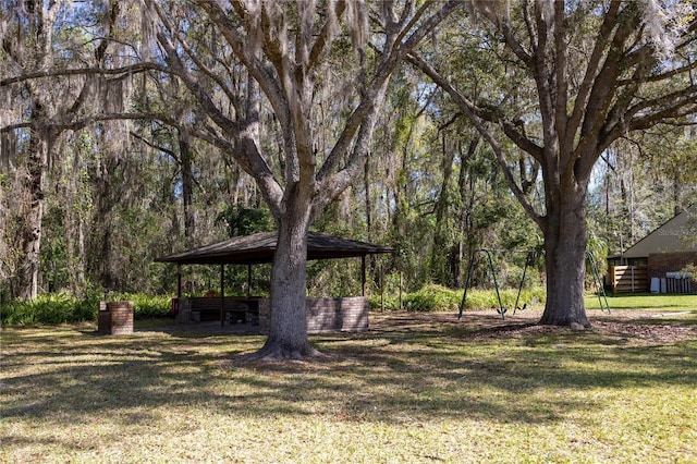 view of yard featuring a forest view