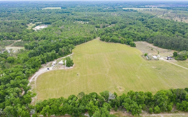 birds eye view of property with a wooded view