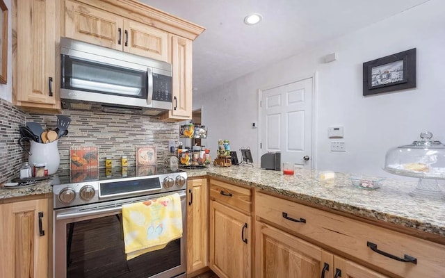 kitchen featuring light stone counters, backsplash, appliances with stainless steel finishes, and light brown cabinets