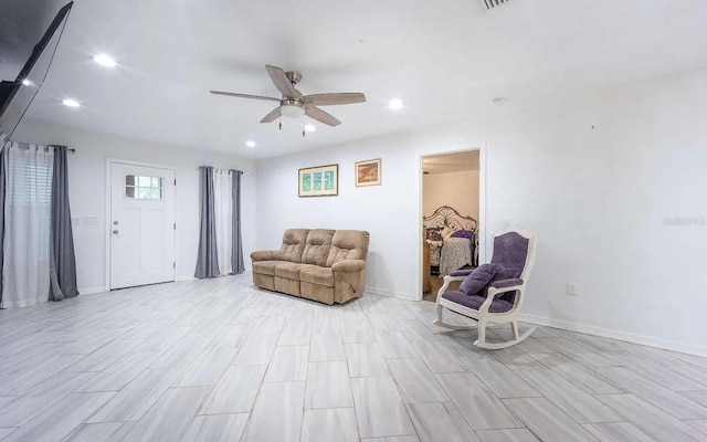 living area with recessed lighting, baseboards, and ceiling fan