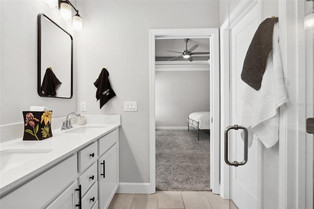 full bathroom with double vanity, a shower stall, a sink, and tile patterned floors