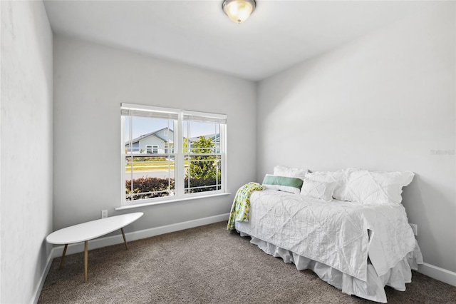 bedroom featuring carpet floors and baseboards