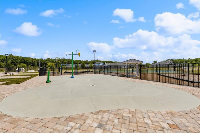 view of property's community with a swimming pool and fence