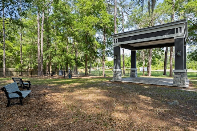 surrounding community featuring fence, a gazebo, and a patio