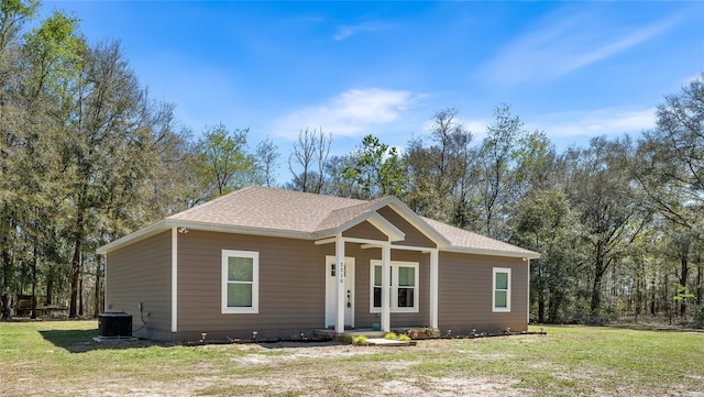 ranch-style home with a porch, central AC, a front lawn, and a shingled roof