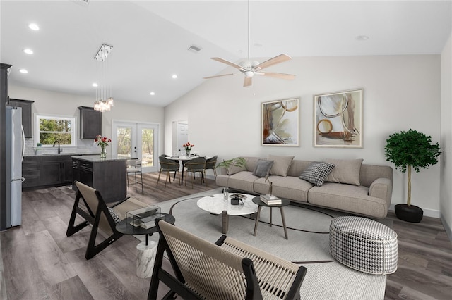 living room with wood finished floors, french doors, visible vents, and vaulted ceiling