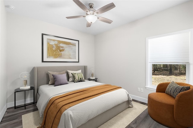 bedroom with baseboards, wood finished floors, and a ceiling fan