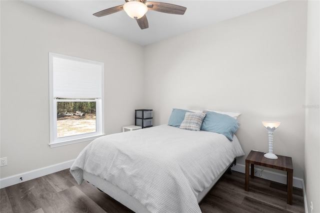 bedroom featuring a ceiling fan, wood finished floors, and baseboards