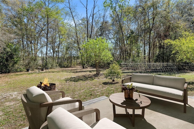 view of patio / terrace with an outdoor living space with a fire pit