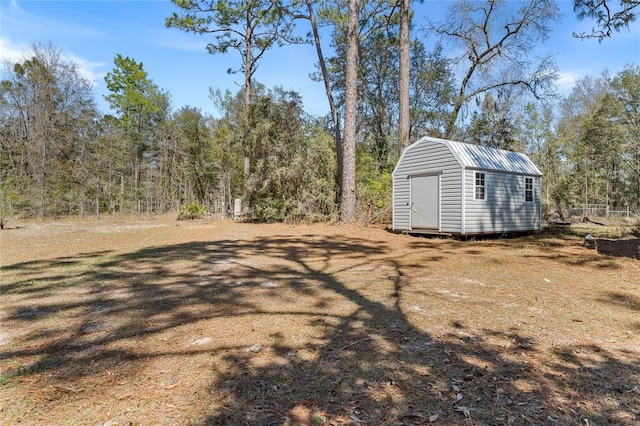 view of yard featuring an outbuilding and a shed