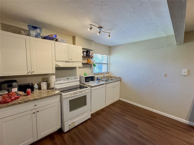 kitchen featuring white appliances, dark wood-style floors, baseboards, a sink, and under cabinet range hood