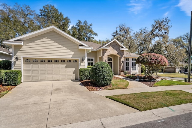 ranch-style house with a garage, brick siding, and concrete driveway