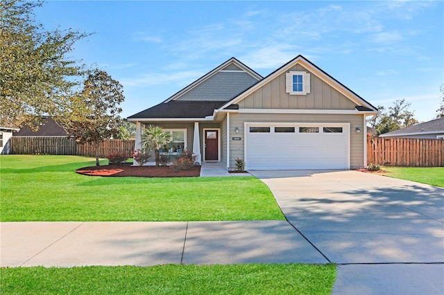 craftsman-style home featuring an attached garage, fence, concrete driveway, a front lawn, and board and batten siding