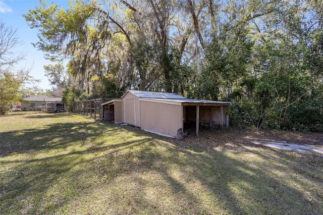 view of yard with an outdoor structure and fence